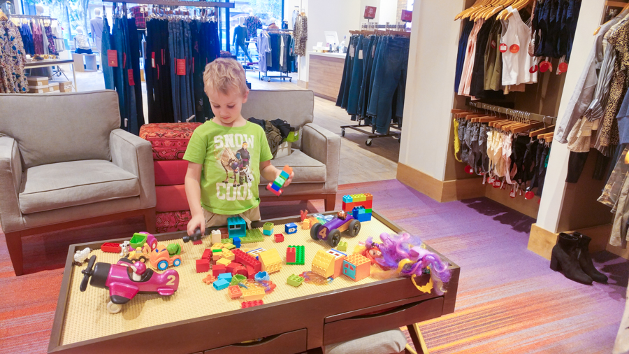 Kids play area while you shop for stylish mom outfits.