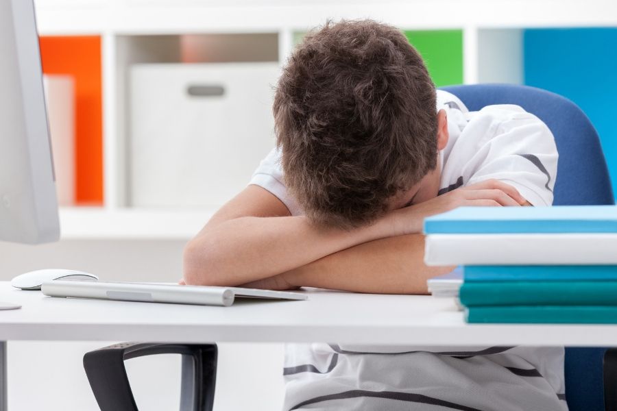 crying kid doing homework