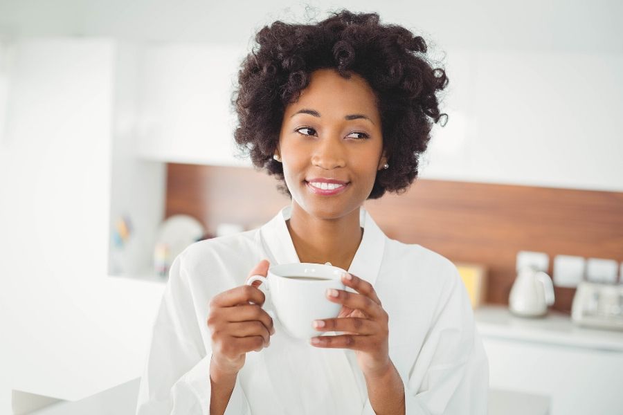 Woman holding cup of coffee and relaxing