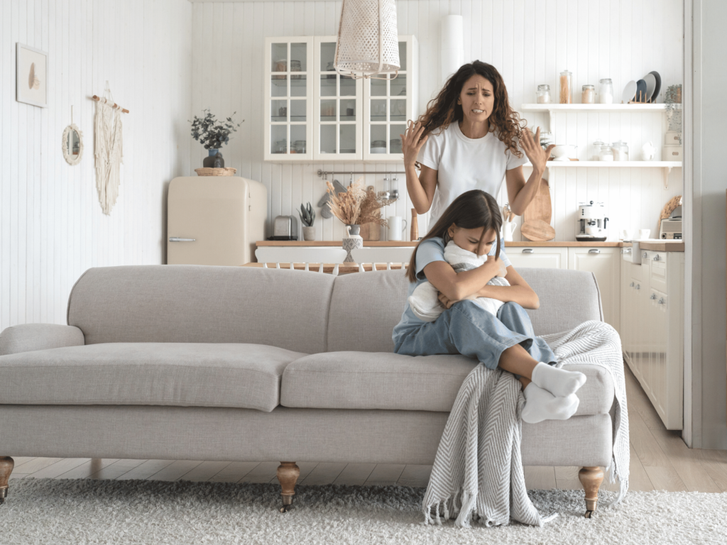 Mom yelling at daughter who is sad and curled up on couch